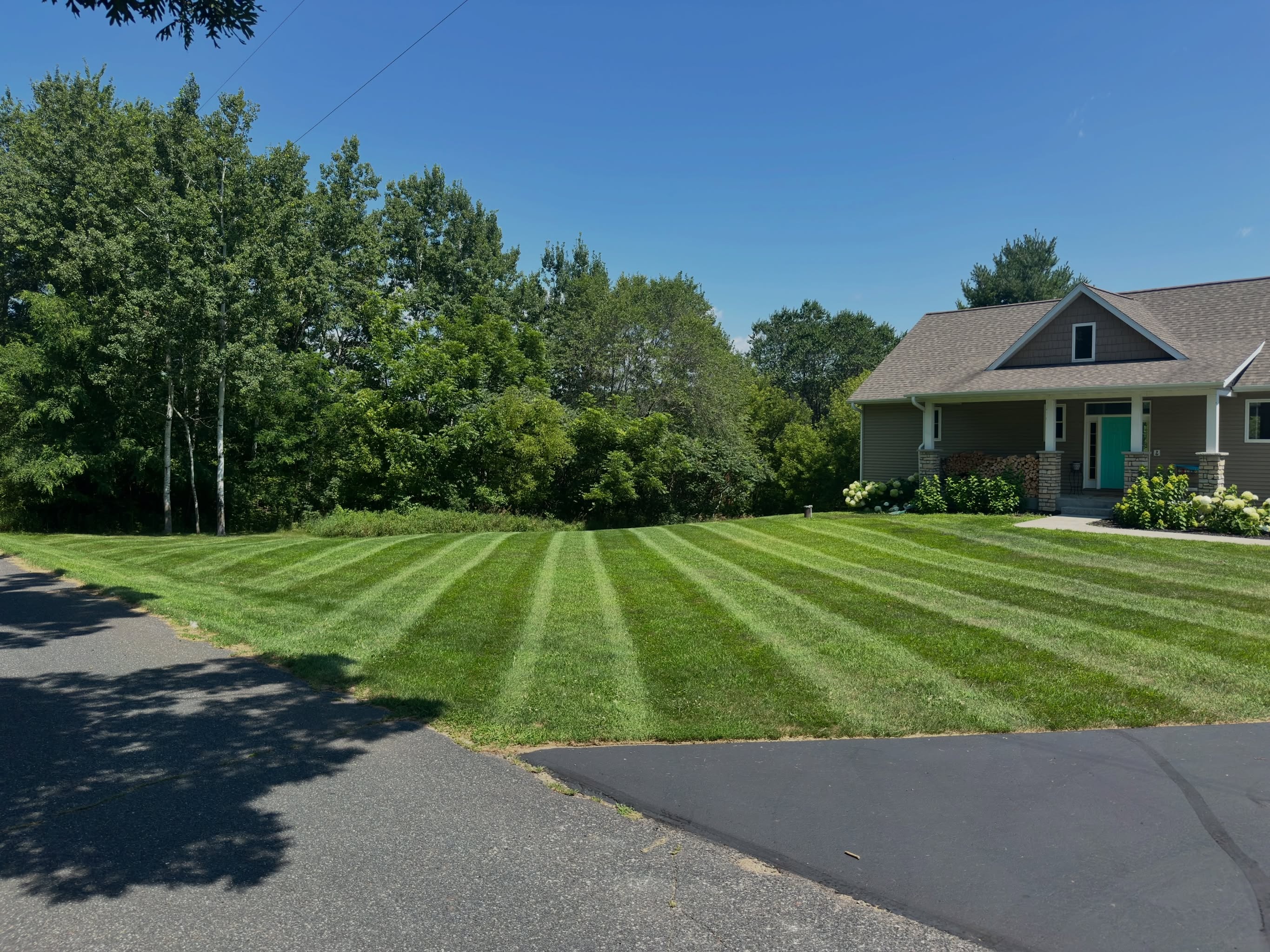 Freshly mowed residential lawn maintained by the A+ Lawn & Landscape crew in Menomonie, WI