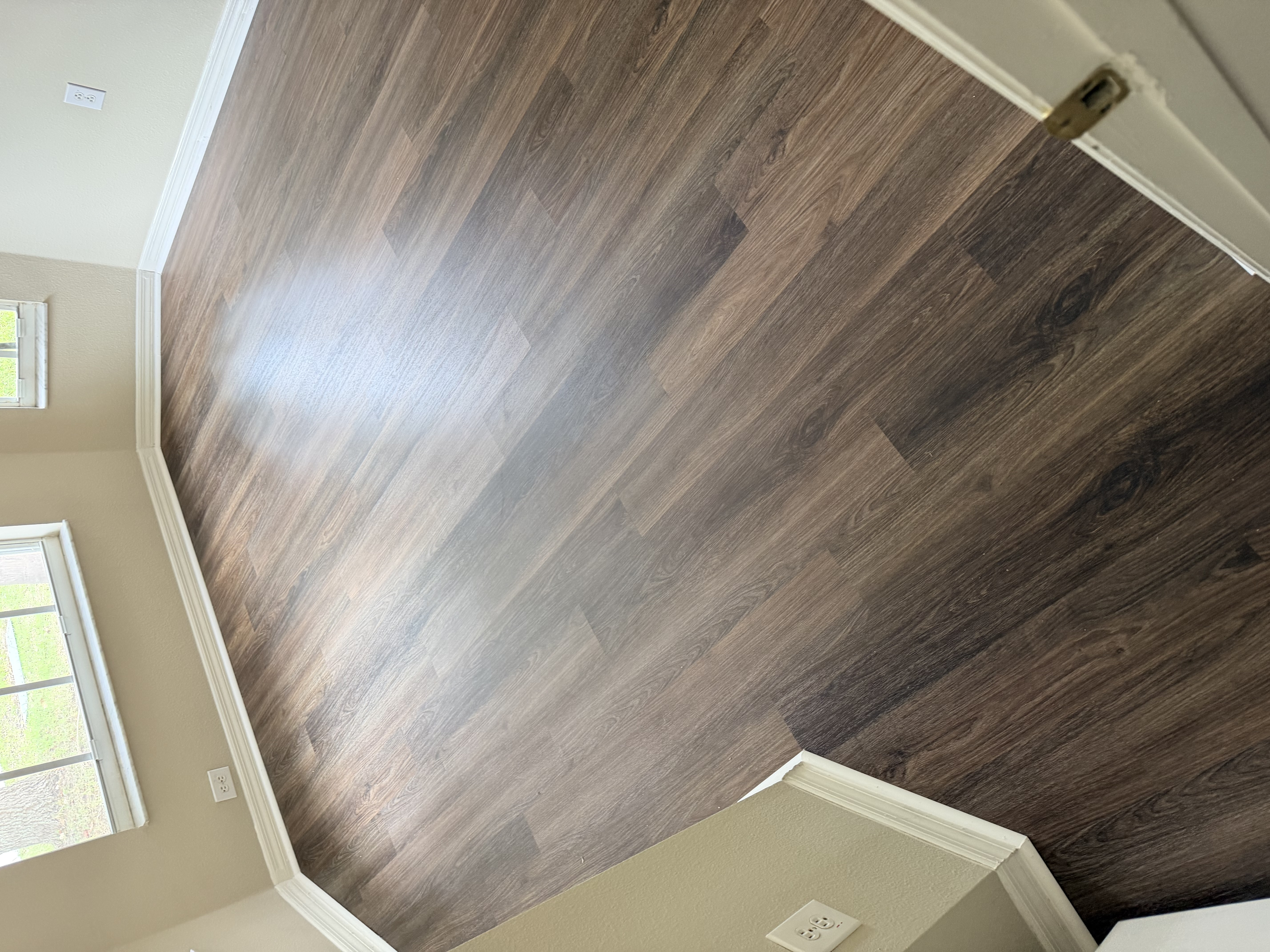 Tampa, FL bay window room with new dark plank flooring