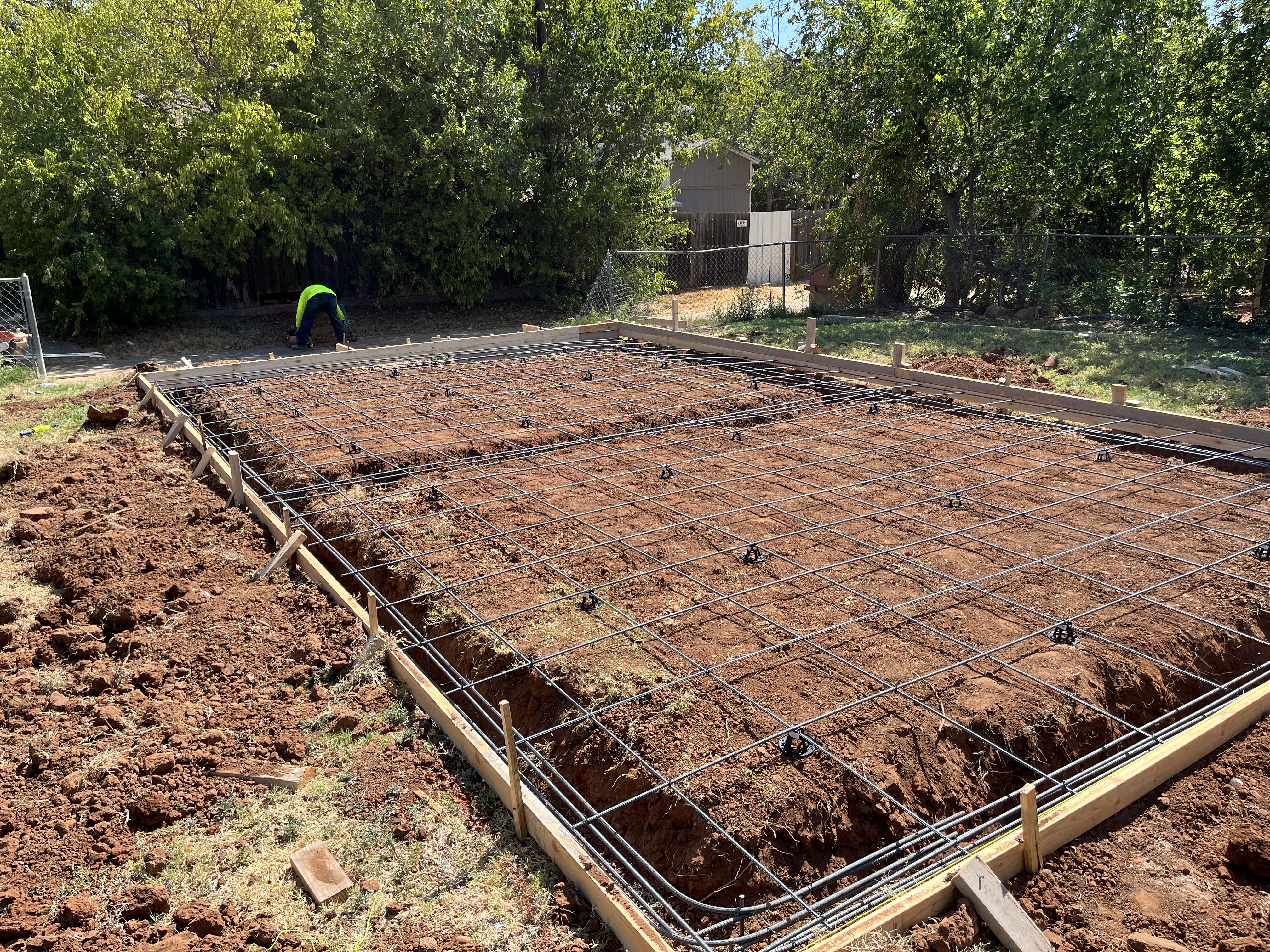 Formwork and rebar grid prepped for an outbuilding foundation by Rock of Ages Concrete LLC
