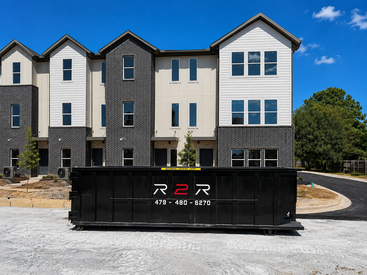 Branded R2R roll-off dumpster on site at a new multi-family development in Northwest Arkansas