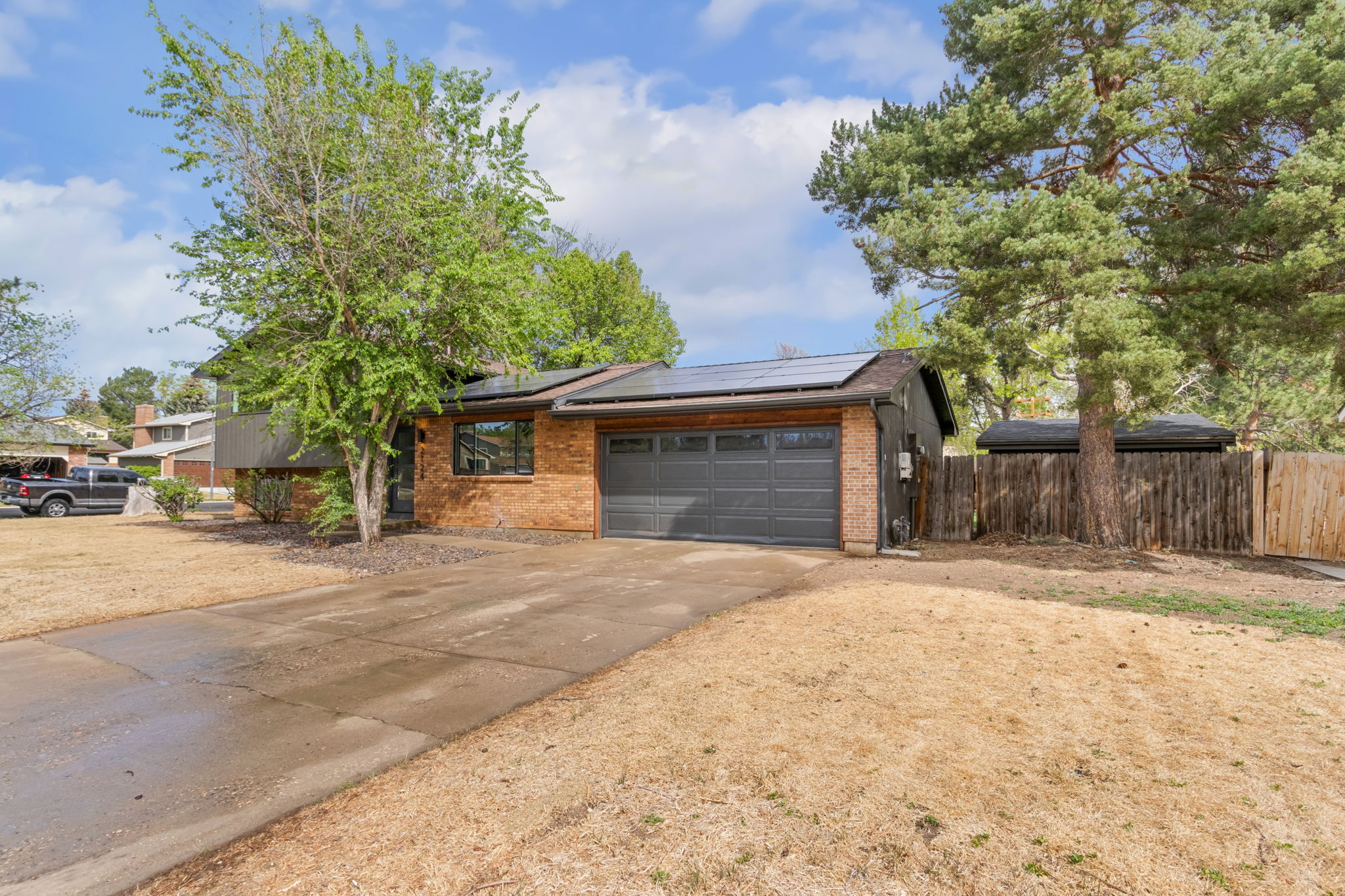 Side of the house with the attached garage, brick below and gray siding above