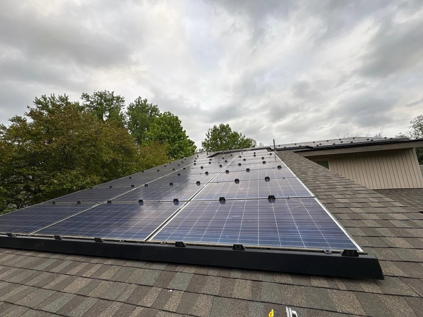 Technician servicing an existing rooftop solar system