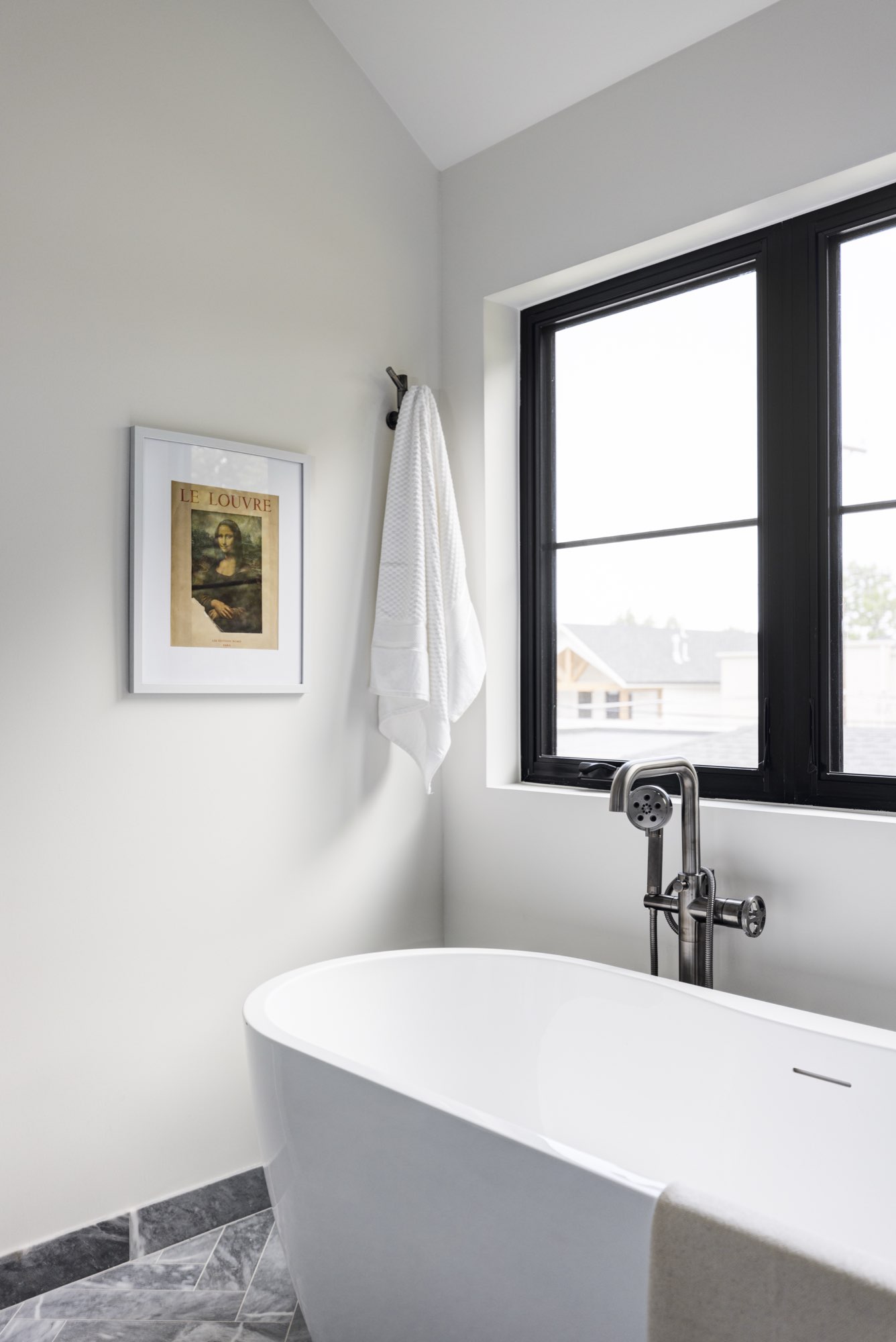 Walk-in glass shower with white slab walls, a built-in bench, a niche and a gray herringbone floor