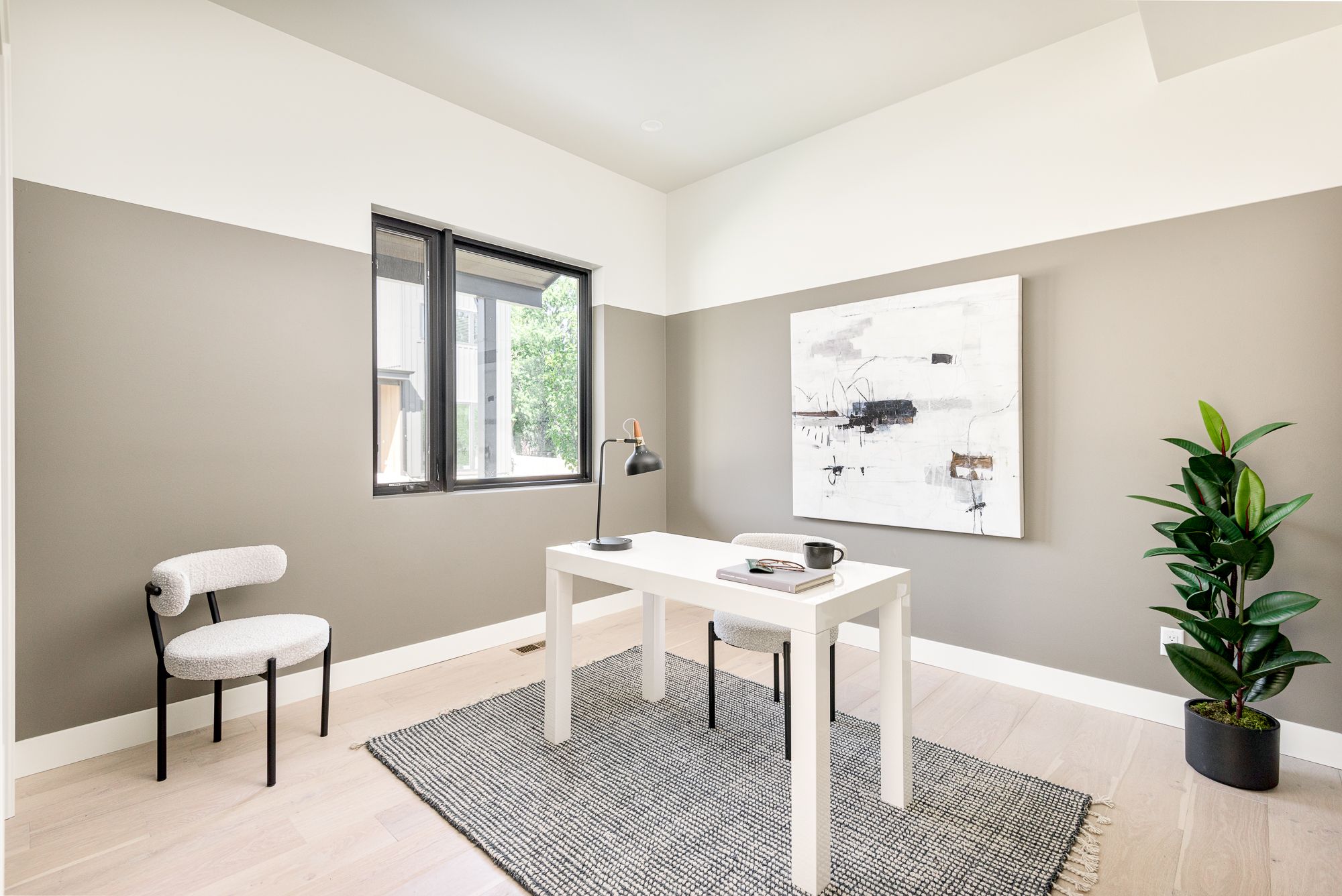 Office with a two-tone taupe and white wall and a desk
