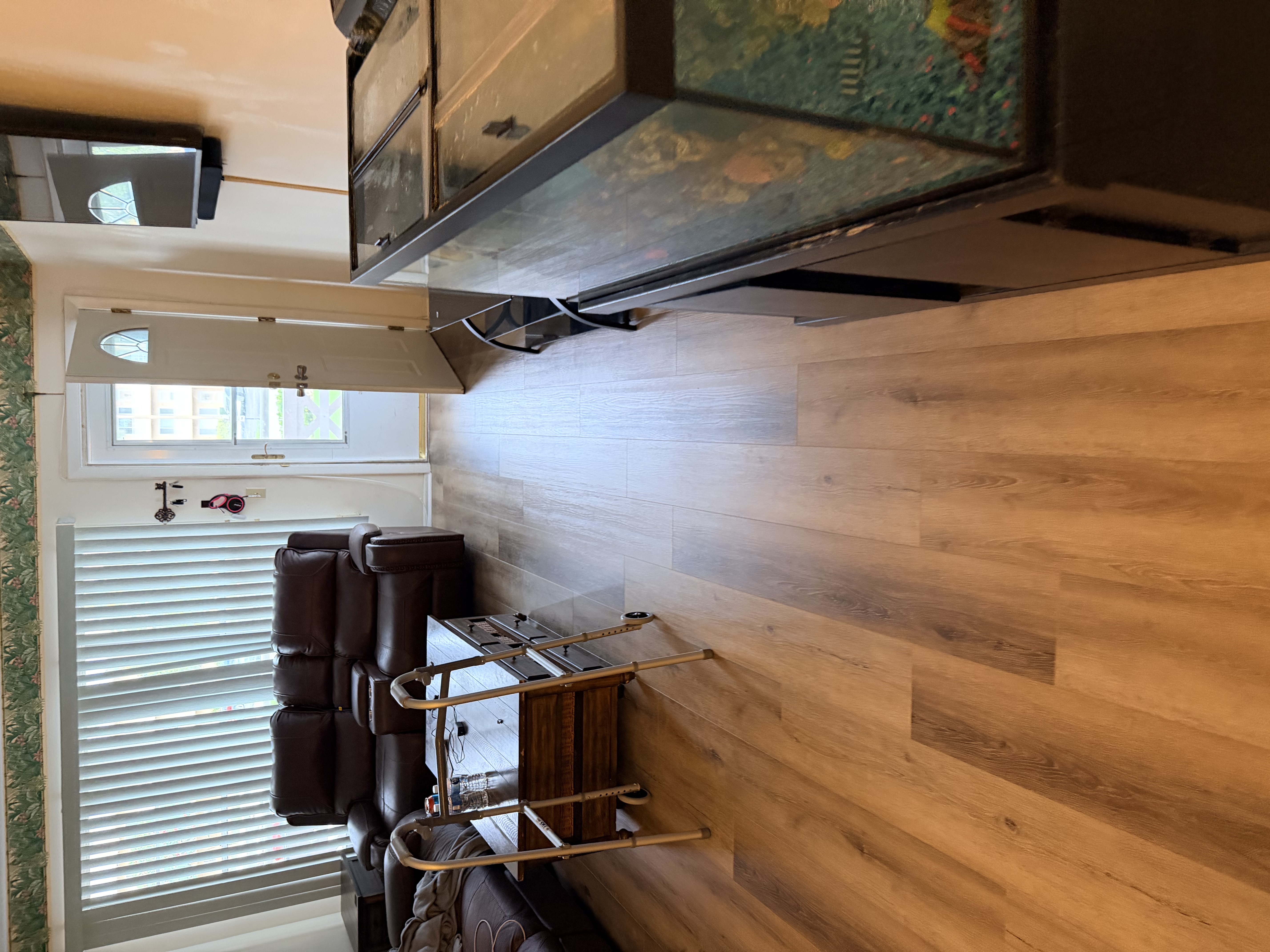 Tampa, FL living room with new honey oak plank flooring and leather furniture