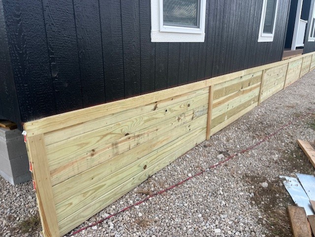 Custom wood skirting installed on a mobile home