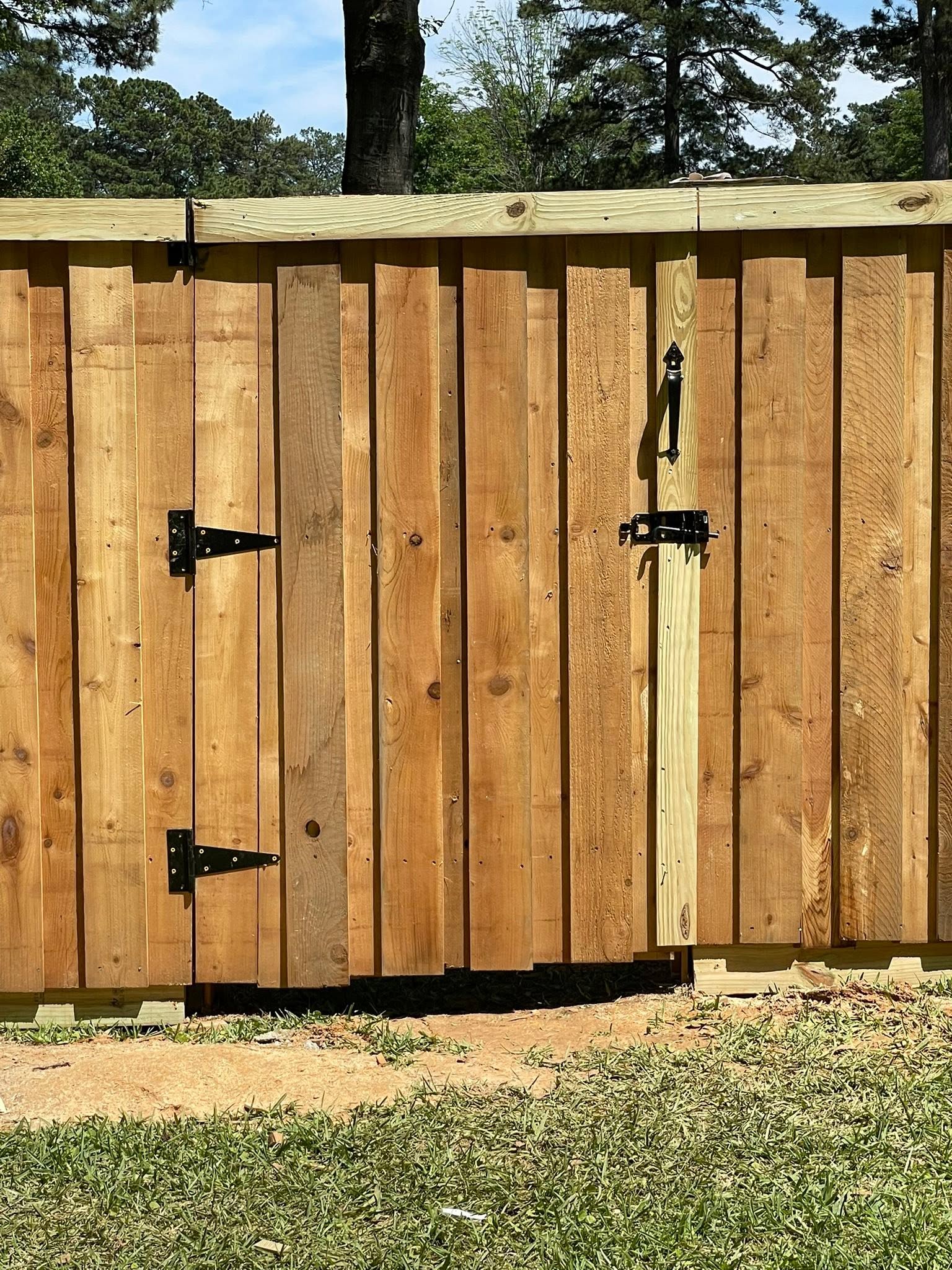 Cedar gate with decorative hardware detail in Texarkana, TX