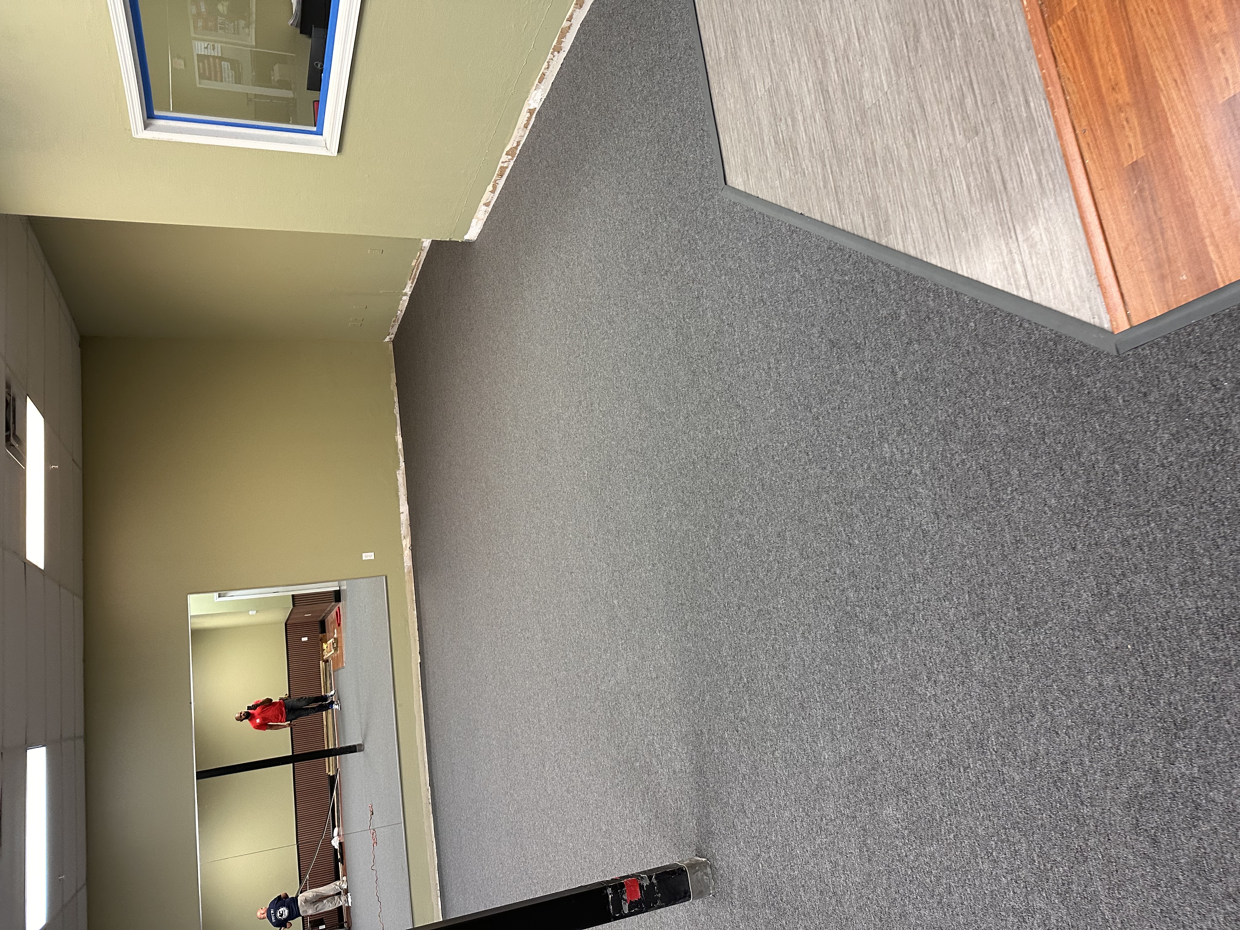 Commercial space in Tampa, FL with new grey carpet and plank flooring installed